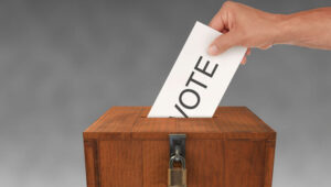 hand-putting-vote-in-ballot-box