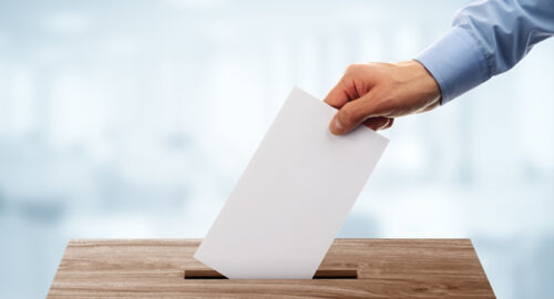 hand-putting-vote-in-ballot-box